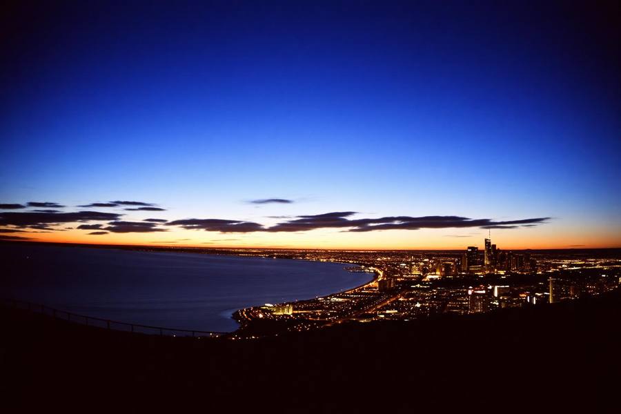 Panoramic golden hour view over San Diego bay and downtown skyline from a hilltop overlook