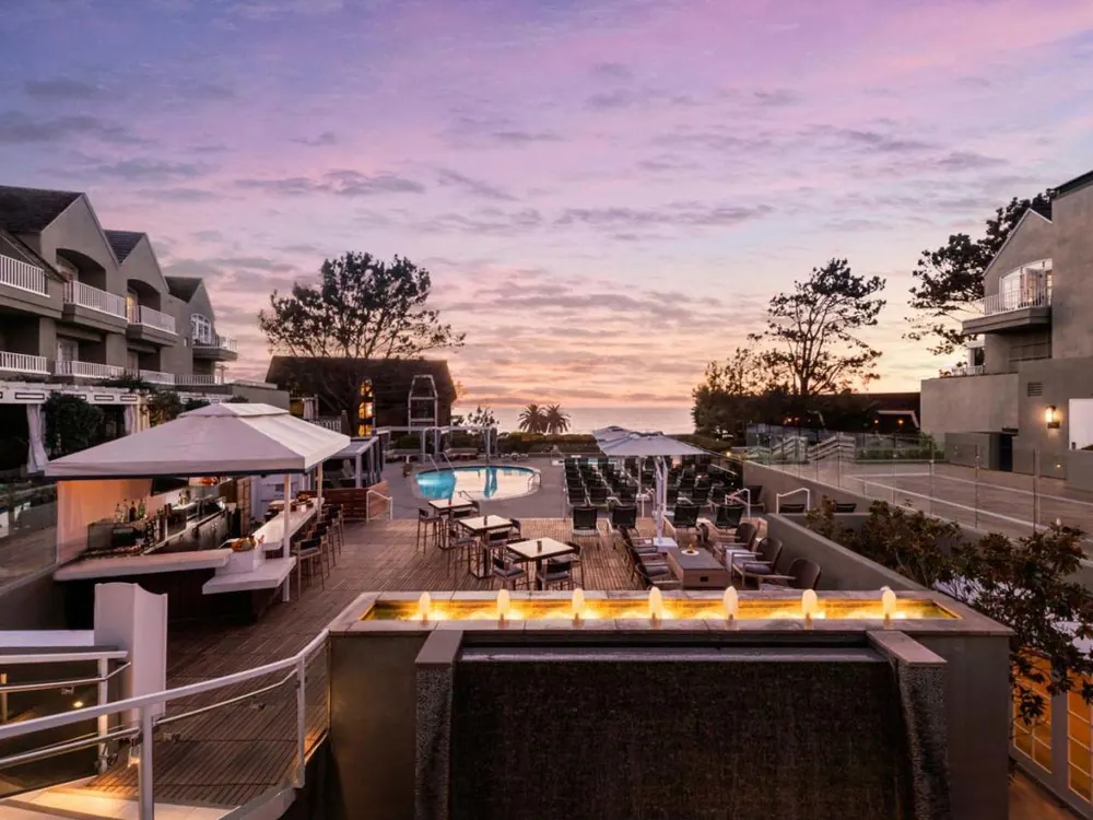 Pool terrace and coastal village grounds at L'Auberge Del Mar