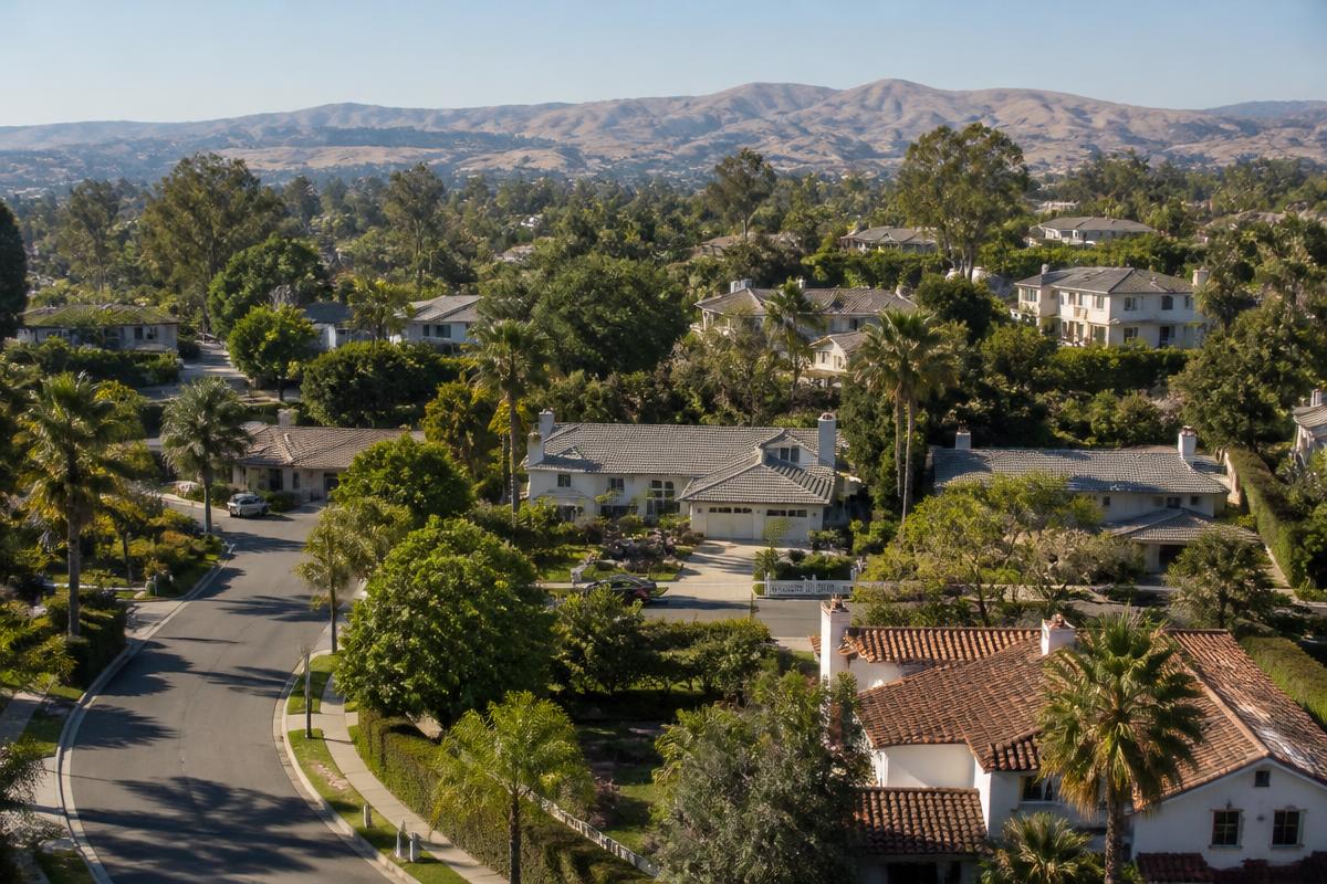 Aerial view of a Poway neighborhood with large-lot single family homes and dry golden hills behind