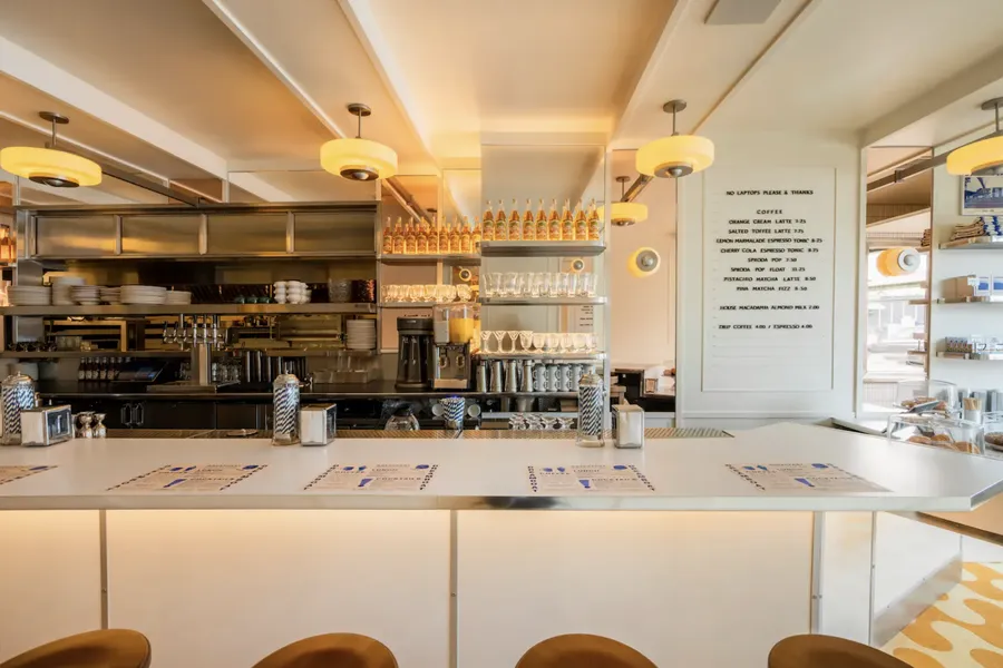 The pastel dining room and open kitchen at Morning Glory in Little Italy, San Diego