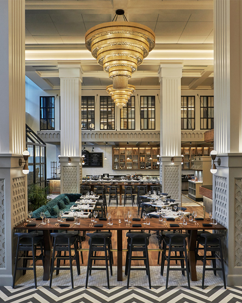 Dining room at a Pendry San Diego restaurant set for dinner service