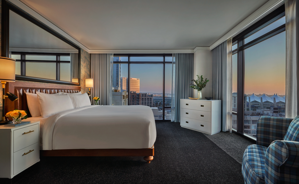 Grand suite guest room at the Pendry San Diego with floor-to-ceiling windows and city views