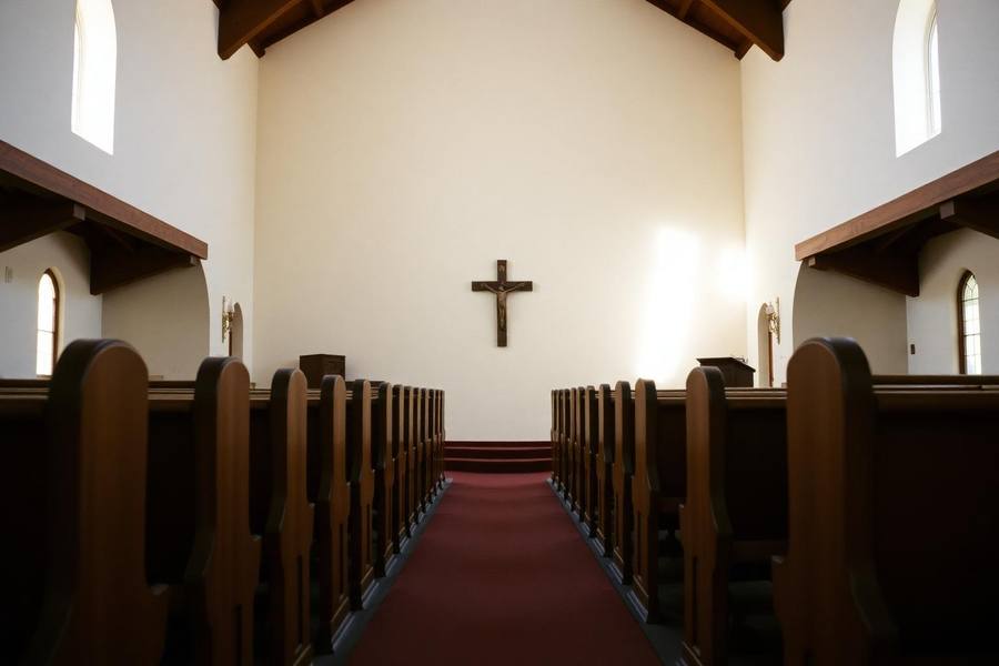 Quiet mission-style church interior in San Diego with wooden pews and light through arched windows
