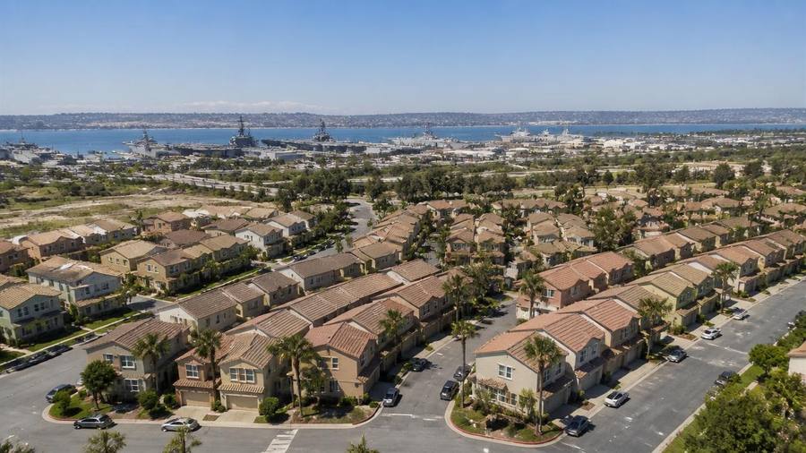 Aerial view of San Diego military housing neighborhood with naval base waterfront in the distance