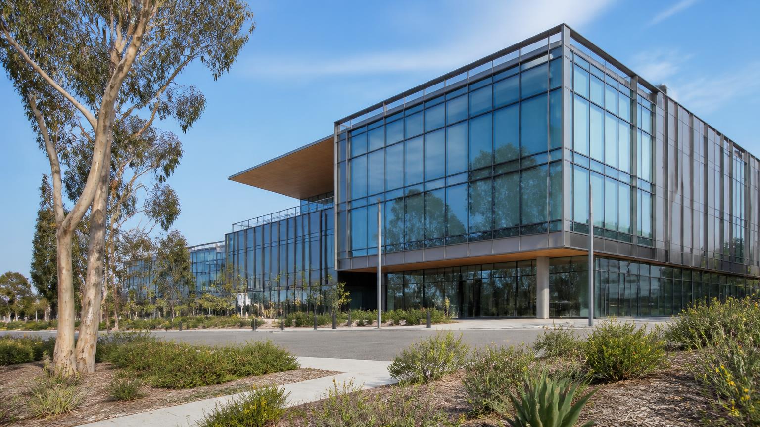 Modern glass life-science laboratory building surrounded by eucalyptus trees in the Torrey Pines area of San Diego