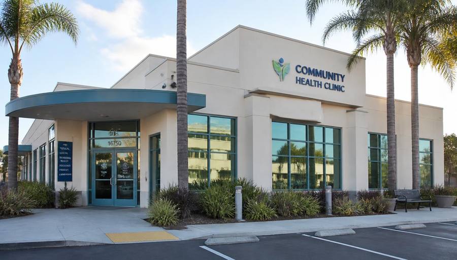 Bright modern community health clinic building with palm trees and a welcoming entrance in San Diego