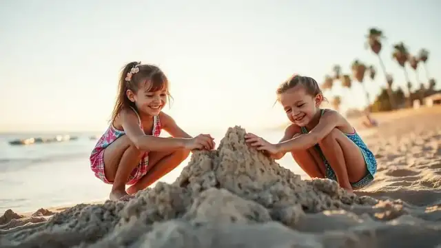 Two kids building a sandcastle on a sunny San Diego beach at golden hour